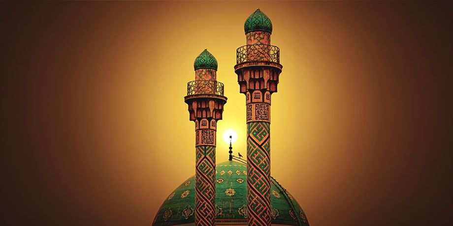 Two spires peek above a green dome of a building