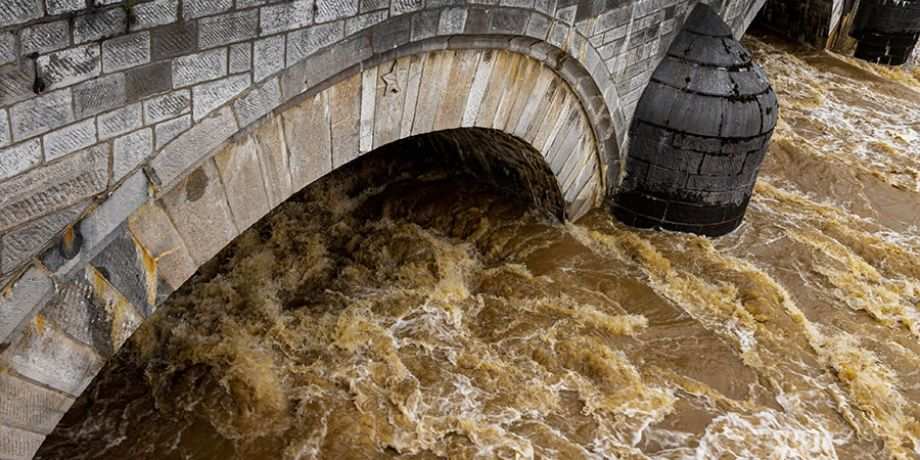 Rushing water under a bridge