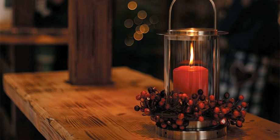 A lighted candle on a table