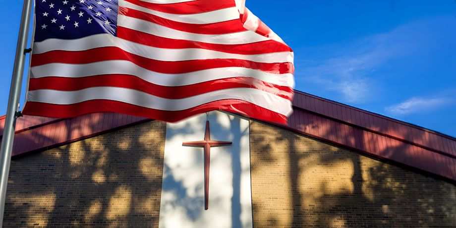 American Flag flying in front of a church