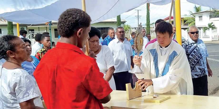 Columban Fr. Carlo Jung Euikyun with parishioners during the Corpus Christi Sunday procession