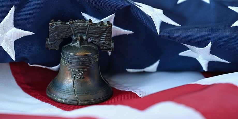 The Liberty Bell setting on an American Flag