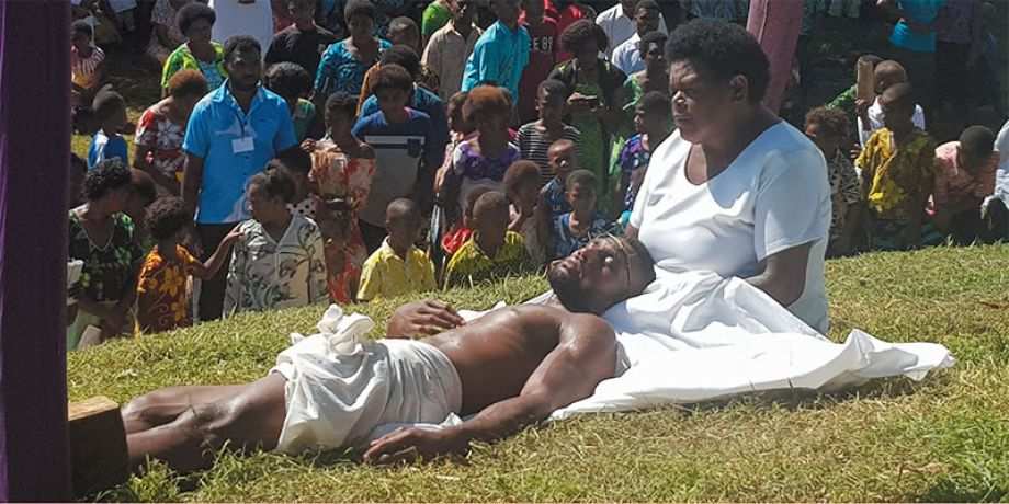 Actors portray Jesus in the arms of his mother.