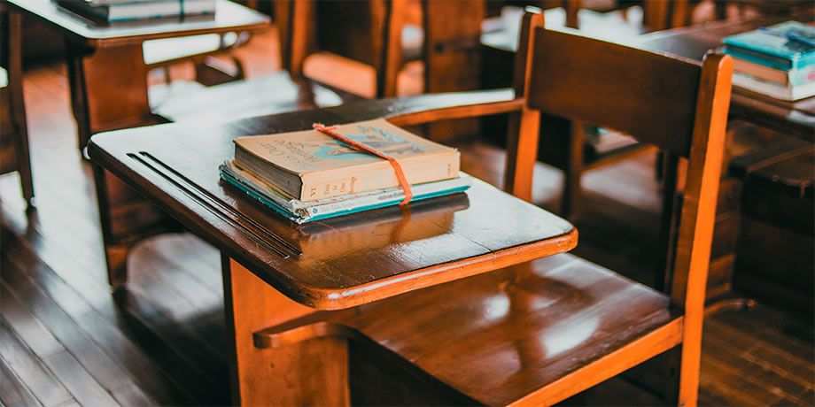 School desks with books on them
