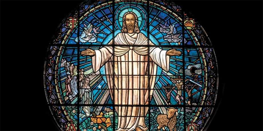 Stained glass window of a compassionate Jesus 