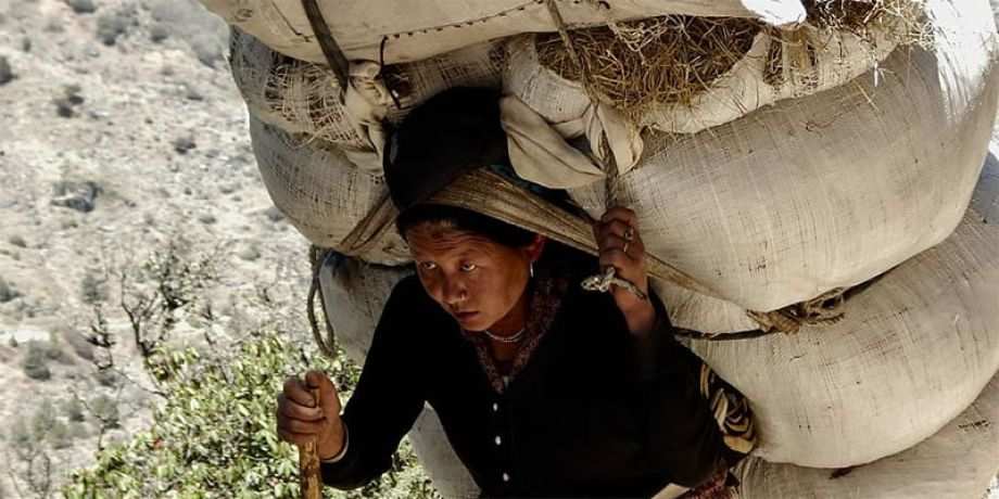 Woman carrying heavy load