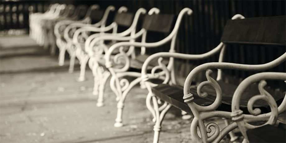 Empty chairs lined up outdoors