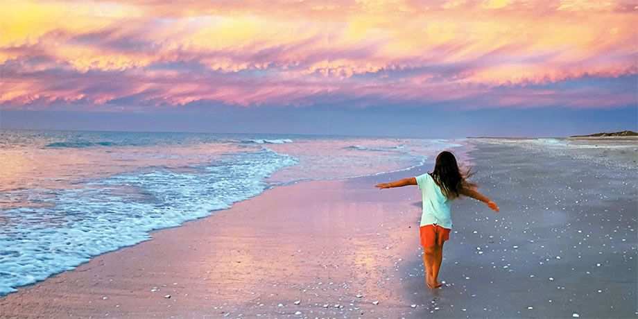 A young girl running on the beach