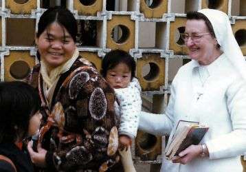 Sr. Damien with a mother and child at the Caritas Center in Fanling.
