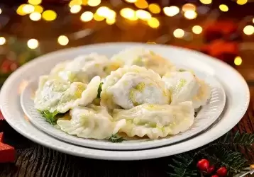 Christmas dumplings stuffed with mushroom and cabbage on a white plate.