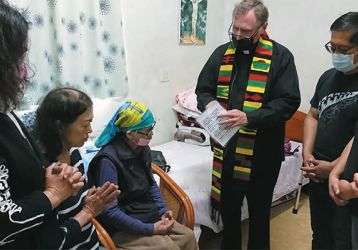 Fr. Larry Barnett with Granny MaHong, seated wearing head scarf