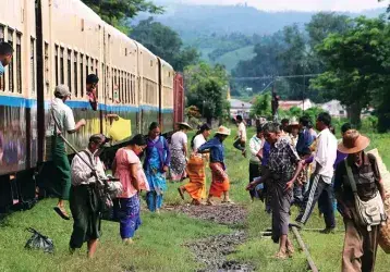 Refugees step off a train in Myanmar