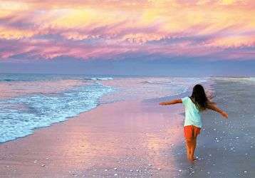 A young girl running on the beach